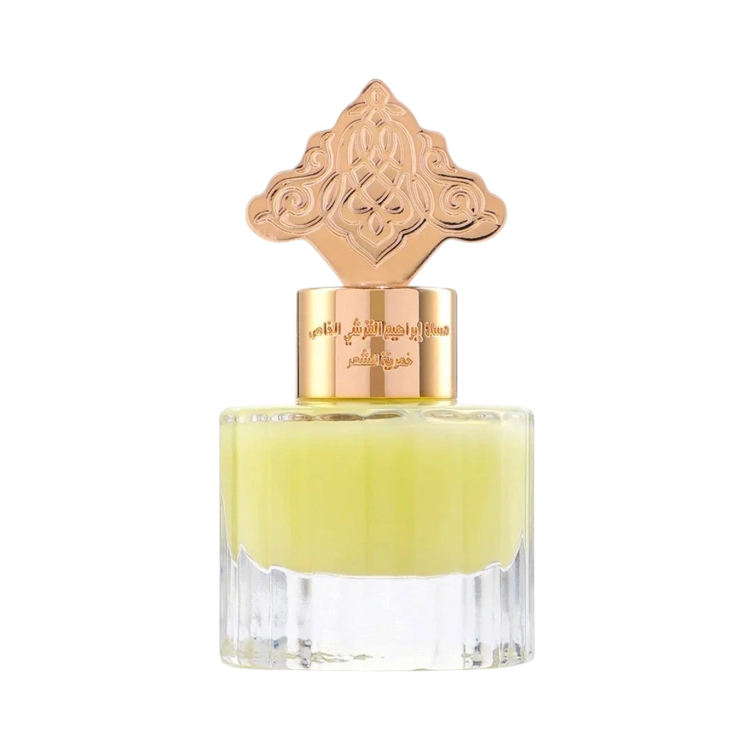 Hadiyyeh Ibraq cardamom musk hair mist in a clear glass bottle with an ornate rose gold decorative cap.