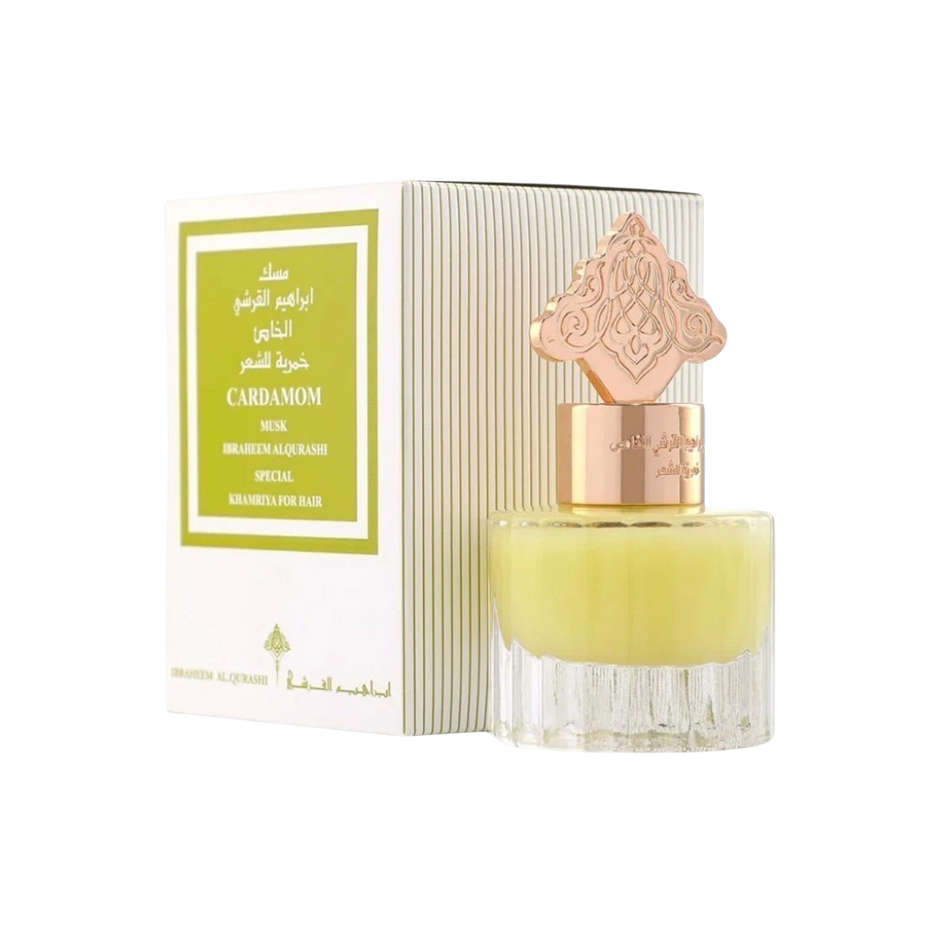 Hadiyyeh Ibraq Cardamom Musk hair mist in a clear glass bottle with a decorative gold cap next to its white box.