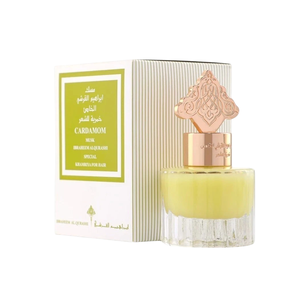 Hadiyyeh Ibraq Cardamom Musk hair mist in a clear glass bottle with a decorative gold cap next to its white box.