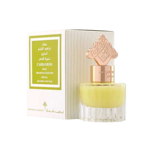 Hadiyyeh Ibraq Cardamom Musk hair mist in a clear glass bottle with a decorative gold cap next to its white box.