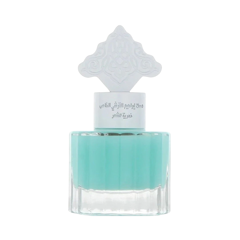 Hadiyyeh IBRAQ Powder Musk hair mist in a clear glass bottle with a decorative white cap and light blue liquid.