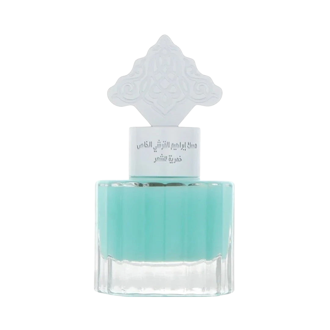 Hadiyyeh IBRAQ Powder Musk hair mist in a clear glass bottle with a decorative white cap and light blue liquid.